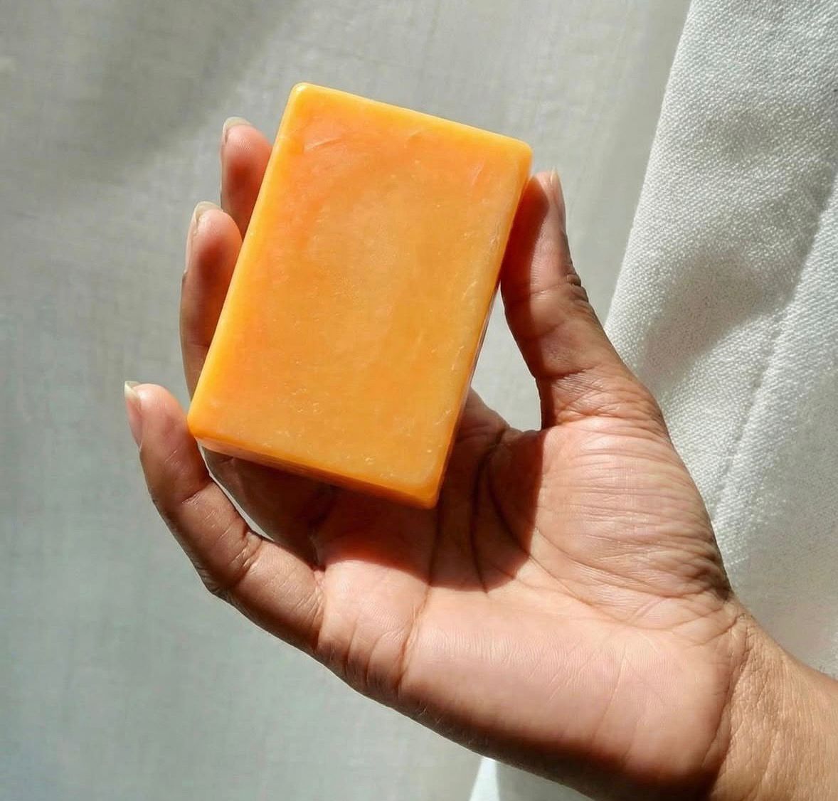 Jabón BlanqueaOGT naranja en mano